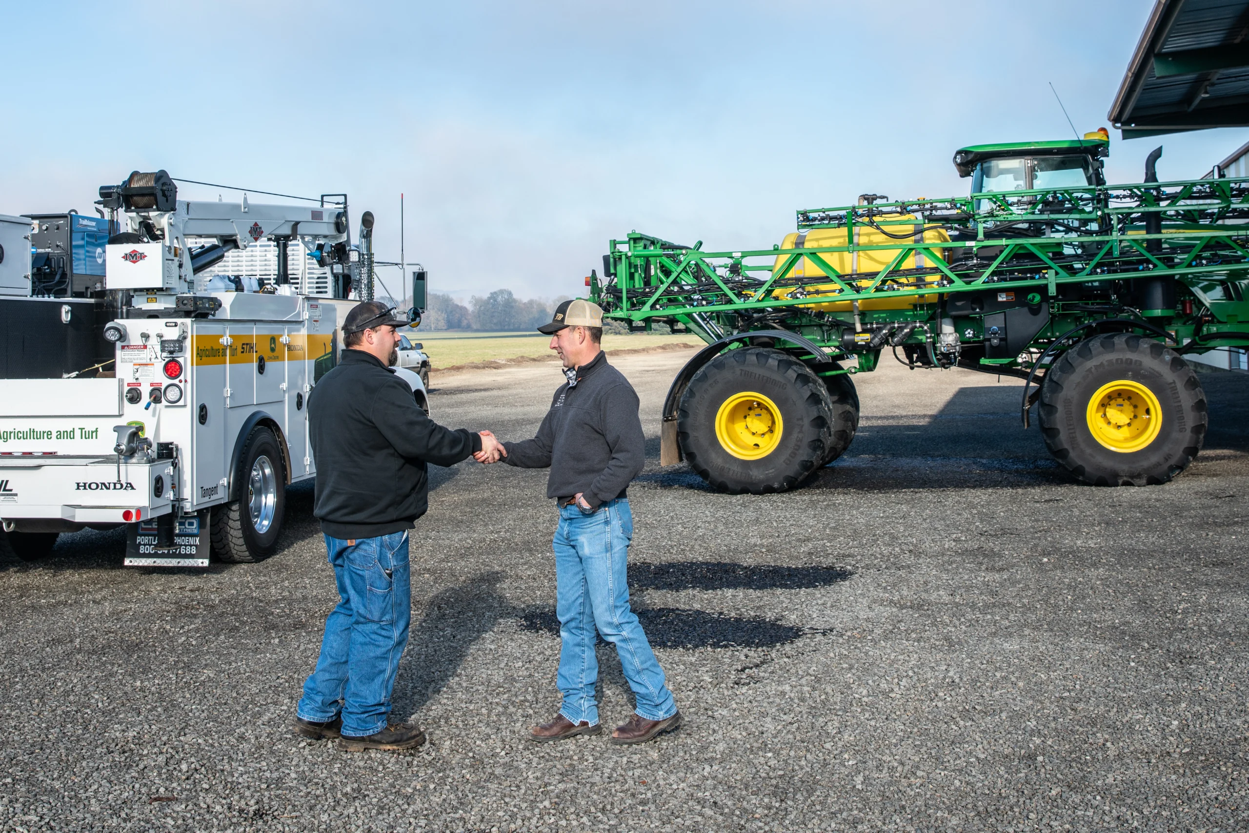 Two service technicians shaking hands