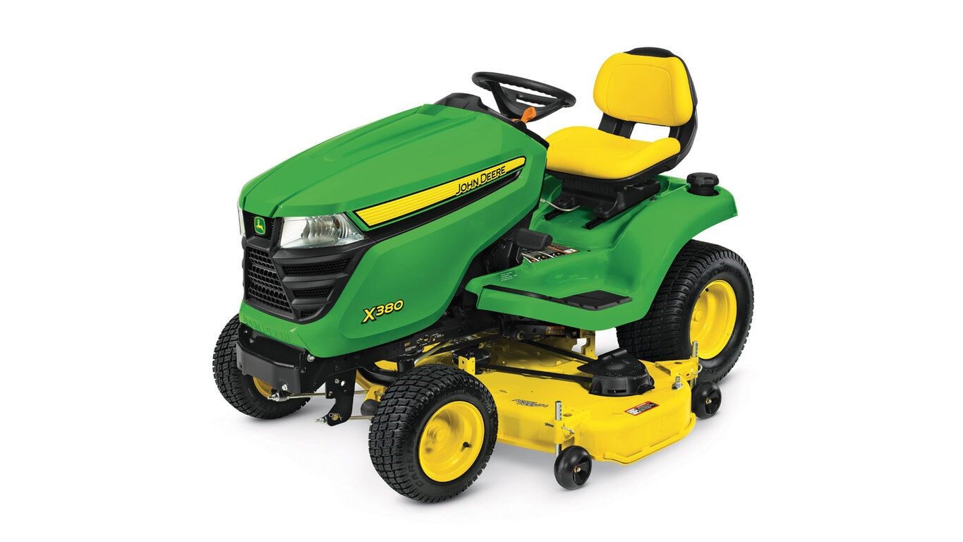 Green and yellow ride-on lawn mower with yellow seat and mowing deck, viewed from the side angle.